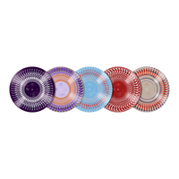 Five decorative round plates with intricate radial patterns are lined up horizontally on a solid white background. The plates feature different colorways: purple, lavender/orange, light blue, red, and red/orange/gray on white.